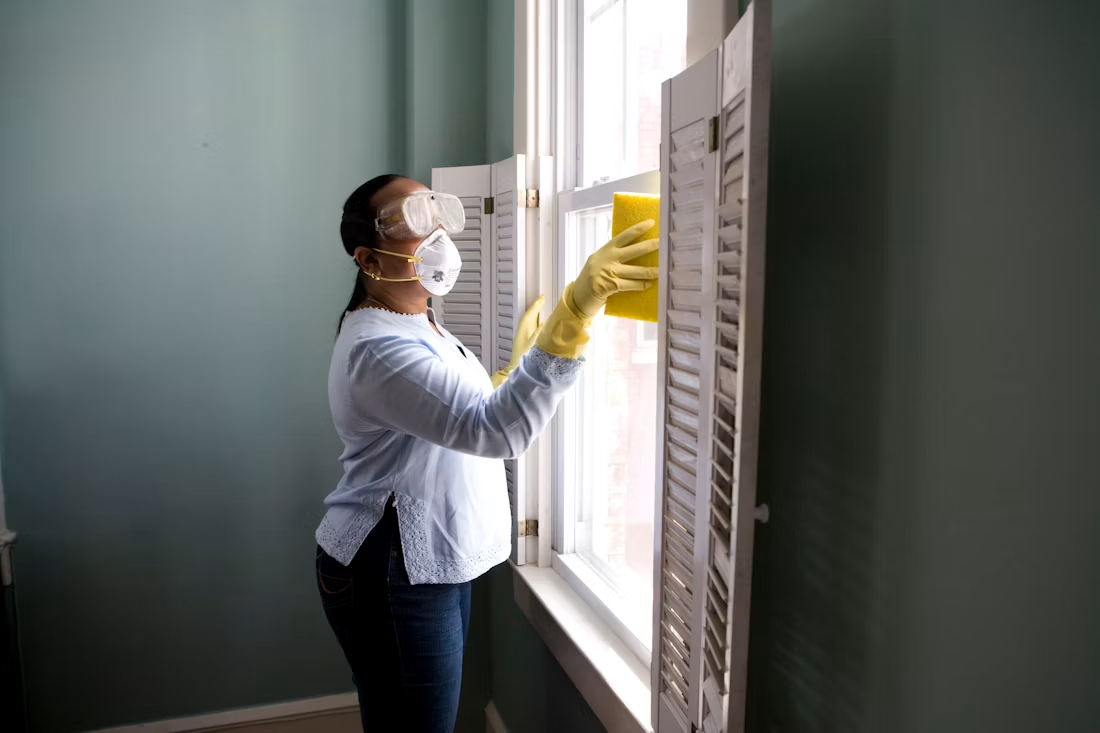 CleanChoice cleaner tidying a bright New York City apartment living room